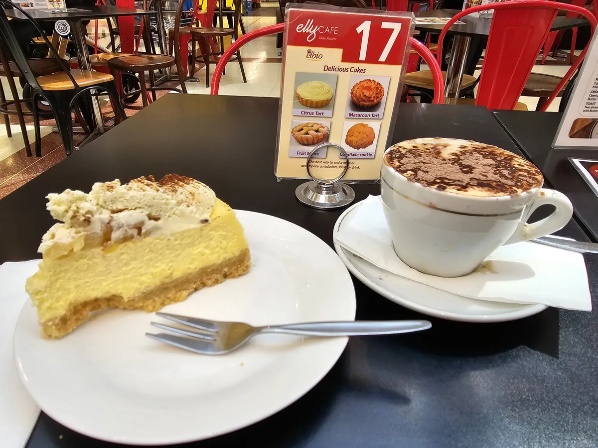 Baked cheesecake with cream and a cappuccino