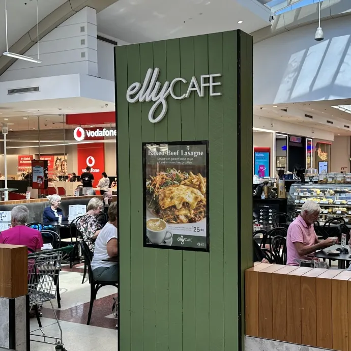 Elly Cafe's green pillar sign and seating on Level 2 of Westfield Marion