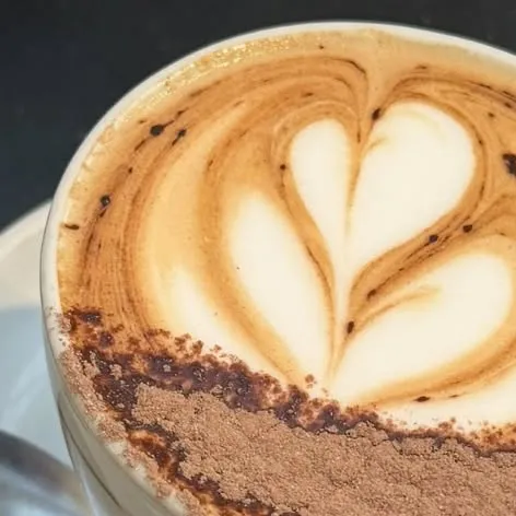 Heart latte art in a coffee at Elly Cafe