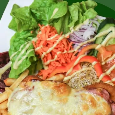 Chicken schnitzel parmigiana with ham, melted cheese, chips and salad